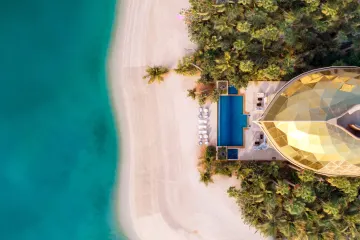 Villa, pool and beachfront from above, source photograph
